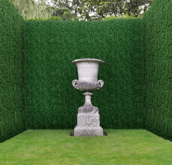 boxwood hedge mat with three walls outside with stone fountain
