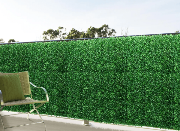 boxwood hedge wall mat on wall with chair outside