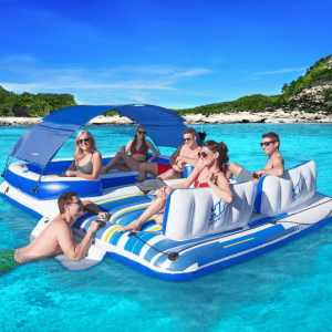 Inflatable pool lounge island with 6 people have a good time on the water with a beach in the background